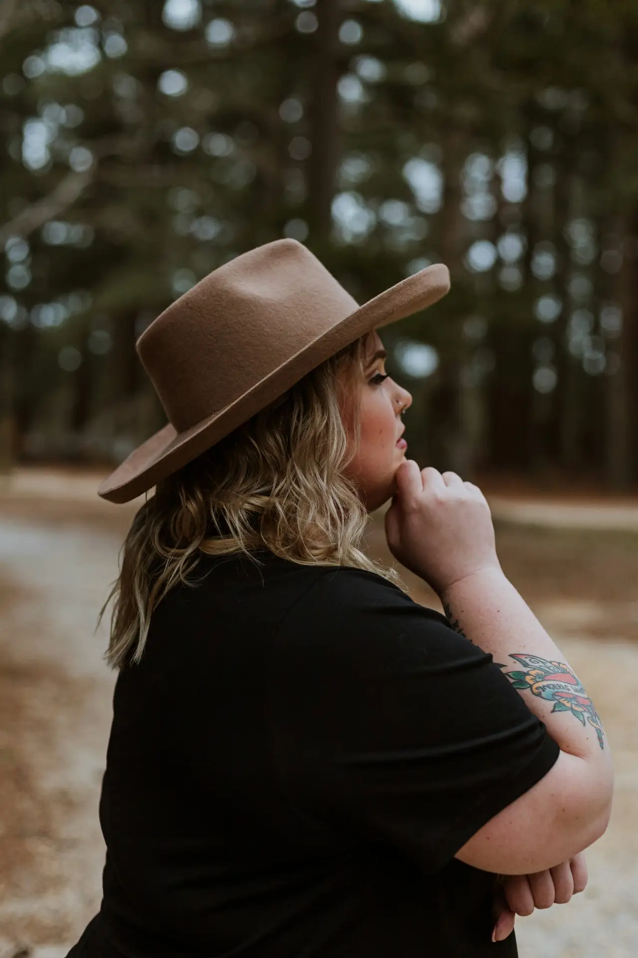 woman in black shirt wearing brown cowboy hat